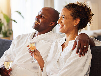Buy stock photo Black couple, champagne and spa therapy on a couch to relax, celebrate and feel zen while together at a hotel for hospitality. Man and woman, happy while drinking alcohol and enjoying quality time