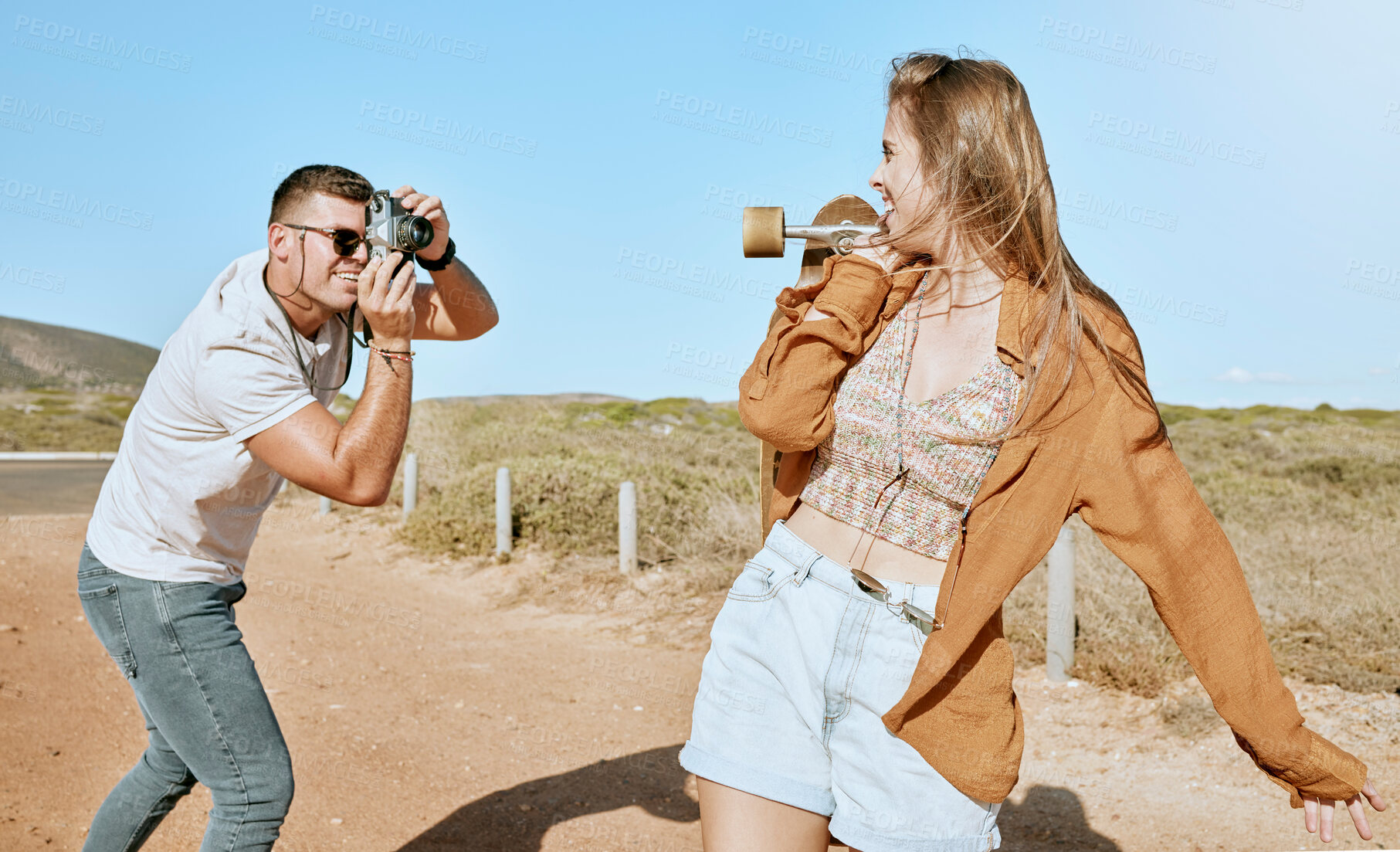 Buy stock photo Photo, skateboard and couple on a road trip in nature to travel during summer. Photographer, love and man with a vintage camera and picture of an influencer ready for skateboarding in countryside