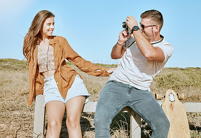 Buy stock photo Couple outdoor, man and woman with camera for photo, happiness and adventure together in nature. Photography, skateboard and road trip with happy, smile and pose on vacation, holiday or travel in sun