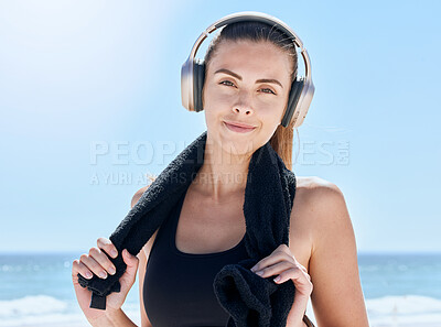 Buy stock photo Fitness, music and portrait of woman at the beach for training, workout and health. Relax, radio and towel with girl and headphones after exercise for energy, sports and goals in the morning by sea