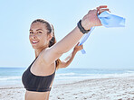 Woman, exercise and fitness at the beach with a resistance band for stretching, workout and training in nature on a summer vacation. Portrait of a model outdoor with energy and motivation for sport