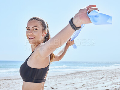 Buy stock photo Woman, exercise and fitness at the beach with a resistance band for stretching, workout and training in nature on a summer vacation. Portrait of a model outdoor with energy and motivation for sport