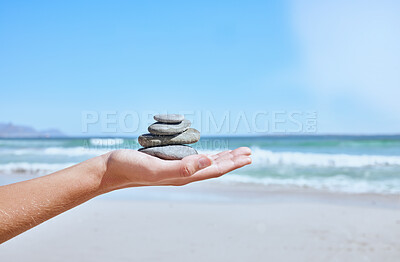 Buy stock photo Rock balance, hand and beach for meditation, yoga or peace exercise in nature by water, Hands holding rocks for chakra, outdoor meditate and spiritual wellness, health and holistic training by sea