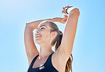 Woman, happy, freedom and smile outdoor after workout while feeling healthy, positive mindset or calm with blue sky background. Young female with happiness, smiling or energy after exercise in nature