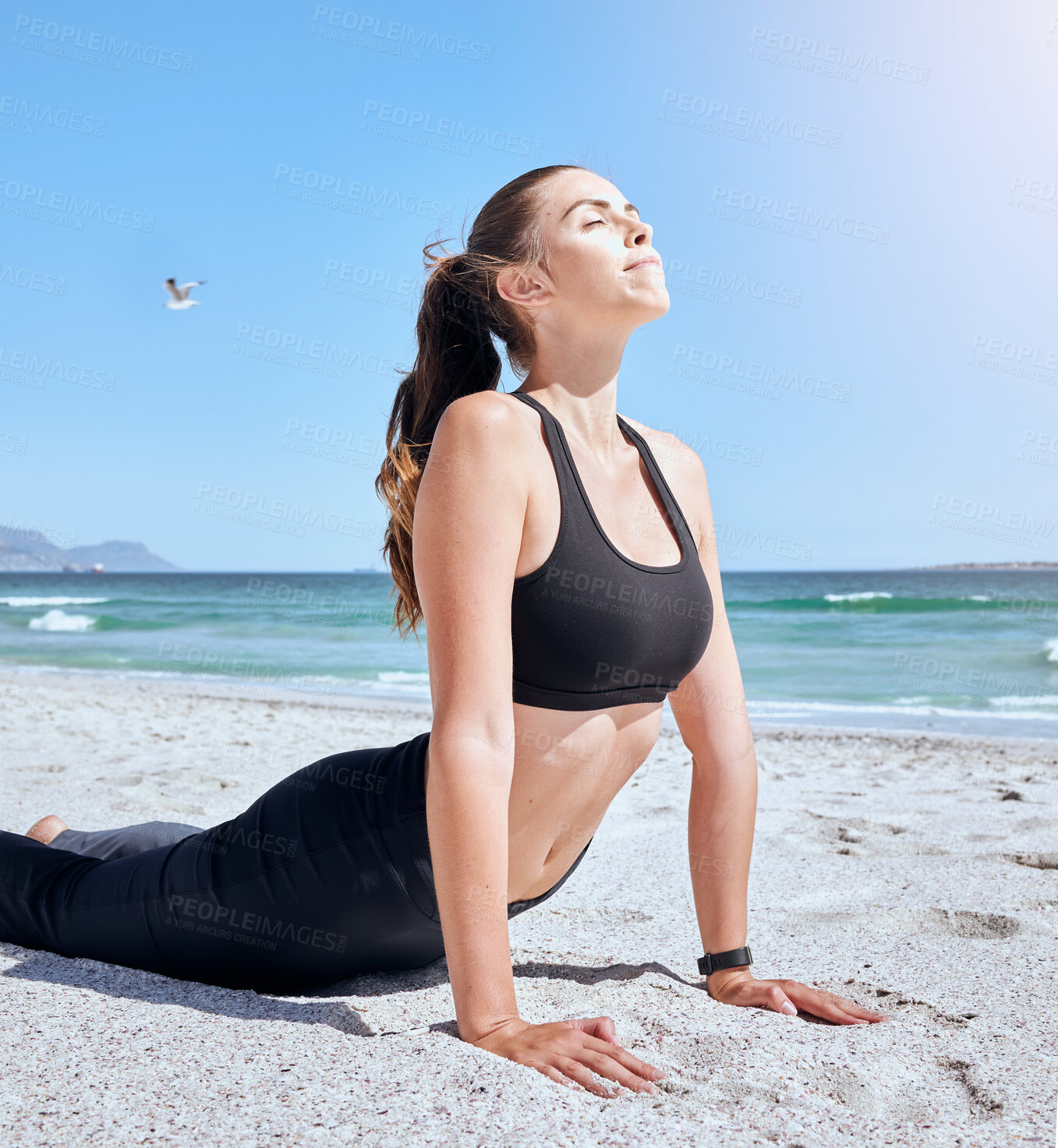 Buy stock photo Beach yoga, health and woman stretching for body healthcare, fitness workout or outdoor freedom exercise. Pilates cobra pose, sky peace and girl training for mindset wellness on ocean tropical island