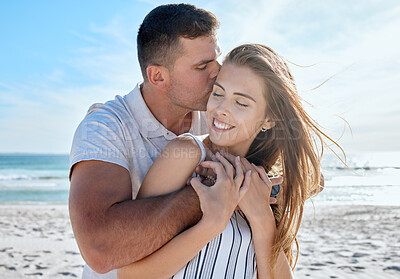 Buy stock photo Love, summer and couple hug at the beach enjoying honeymoon, vacation and holiday together. Travel, nature and man and woman embrace, kiss and hugging by ocean for romance, happiness and affection