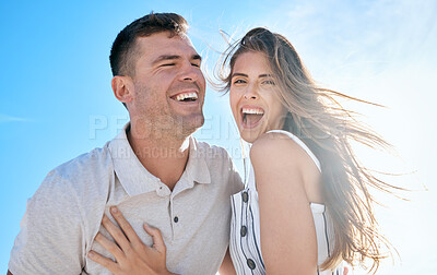 Buy stock photo Couple, people and love with a man and woman having fun, feeling cheerful against a blue sky background. Boyfriend, girlfriend and loving and caring people laughing on a date in nature in summer