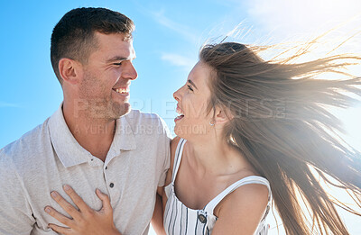 Buy stock photo Couple, love and hug together in summer for travel adventure vacation outdoors. Excited woman, happy man and funny comedy conversation, romance bonding and quality time or support in sunshine