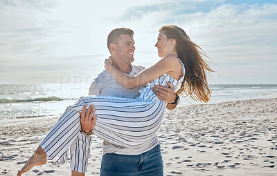 Buy stock photo Couple, love and carrying at beach, holiday and freedom on anniversary, romance and travel together in Hawaii. Man, woman and happy vacation, smile and support in marriage relationship at the ocean