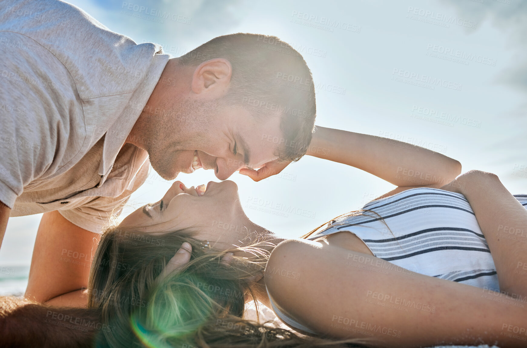 Buy stock photo Happy, love and couple relax at beach, bonding or having fun on vacation, holiday or summer trip. Romance, support and affection of man, woman and lovers ready for romantic kiss outdoors at seashore.