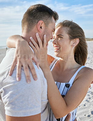 Buy stock photo Love, couple close and hug on beach with smile, romantic and on sand being loving, on holiday and together. Romantic man and woman embrace for relationship, getaway and seaside vacation to celebrate.