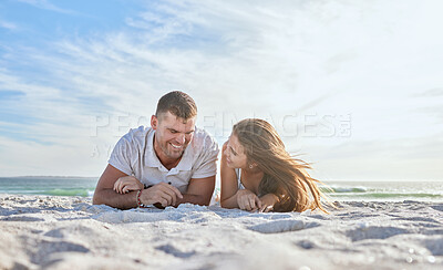 Buy stock photo Love, couple and laying on sand at beach, happy and bonding on vacation, loving or together outdoor for romance. Romantic, man and woman with smile, seaside holiday or relax for relationship and date