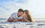 Love, beach and couple laying in sand, happy woman with man on a summer holiday at ocean. Romance, nature and sun, a happy couple from Australia by the sea, sunset and romantic vacation time together