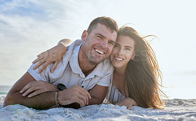 Buy stock photo Portrait, love and relax couple, beach and holiday in summer sunset. Happy woman hug her joyful man while lying in sand at the seashore on vacation or Boyfriend and girlfriend enjoy ocean travel 