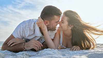 Buy stock photo Love, kiss and couple at the beach for a date, vacation or relax with smile on the sand in summer. Freedom, travel and man and woman with affection, care and peace on a holiday by the sea together