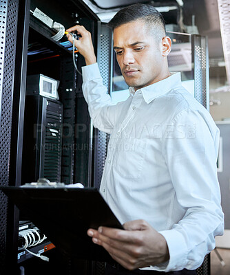 Server room, database and IT support with a man programmer working on an information storage solution. Documents, cybersecurity and cloud computing with a male coder at work in a data center