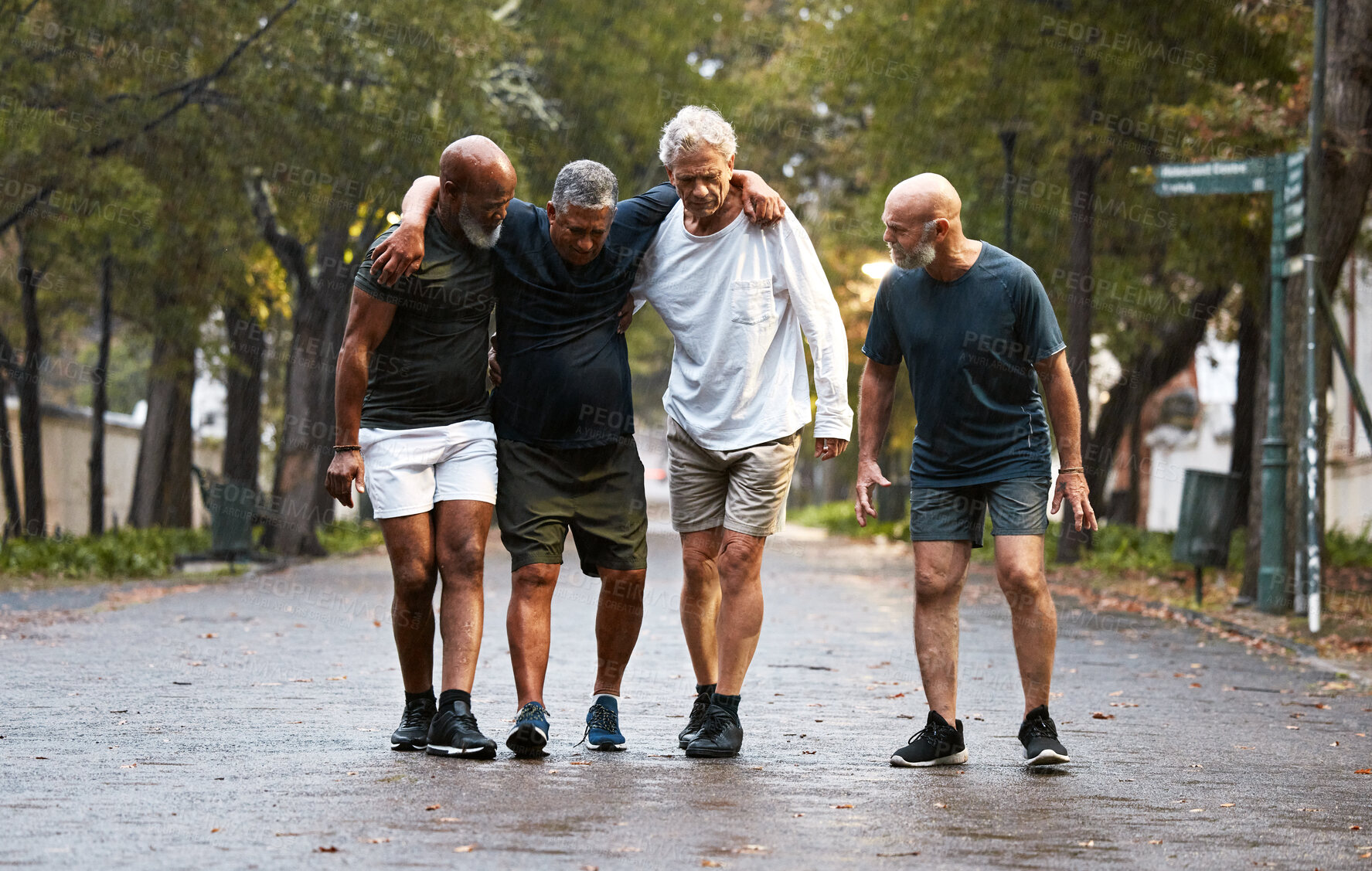 Buy stock photo Mature, friends and fitness pain with men helping friend after injury while training in nature for wellness and health. Exercise, workout and man with leg injury being helped by group working out