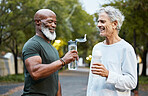 Exercise, water bottle and senior men or friends together at a park for running, walking and fitness during retirement. Happy people in nature for a cardio workout and hydration while talking outdoor
