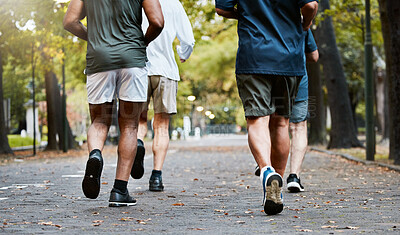 Buy stock photo Fitness, men and running club in park, cropped legs in nature for exercise on garden path together. Motivation, workout and friendship, group of senior friends run, health and wellness in retirement.