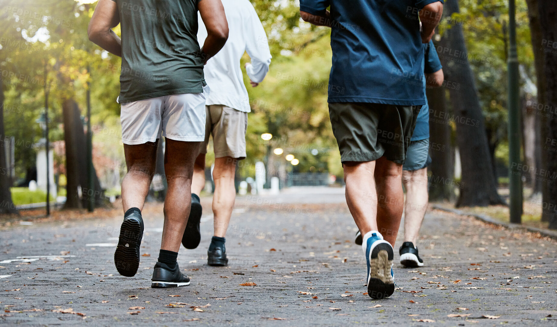 Buy stock photo Fitness, men and running club in park, cropped legs in nature for exercise on garden path together. Motivation, workout and friendship, group of senior friends run, health and wellness in retirement.