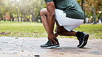 Sports, fitness runner or ankle pain on black man from exercise, training or wellness accident in park, street or nature. Zoom of male athlete health risk, muscle injury from workout while running.
