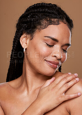 Buy stock photo Black woman, skincare and face with smile in relax for cosmetics or makeup against a brown studio background. African American female touching shoulder in satisfaction for soft beauty skin treatment