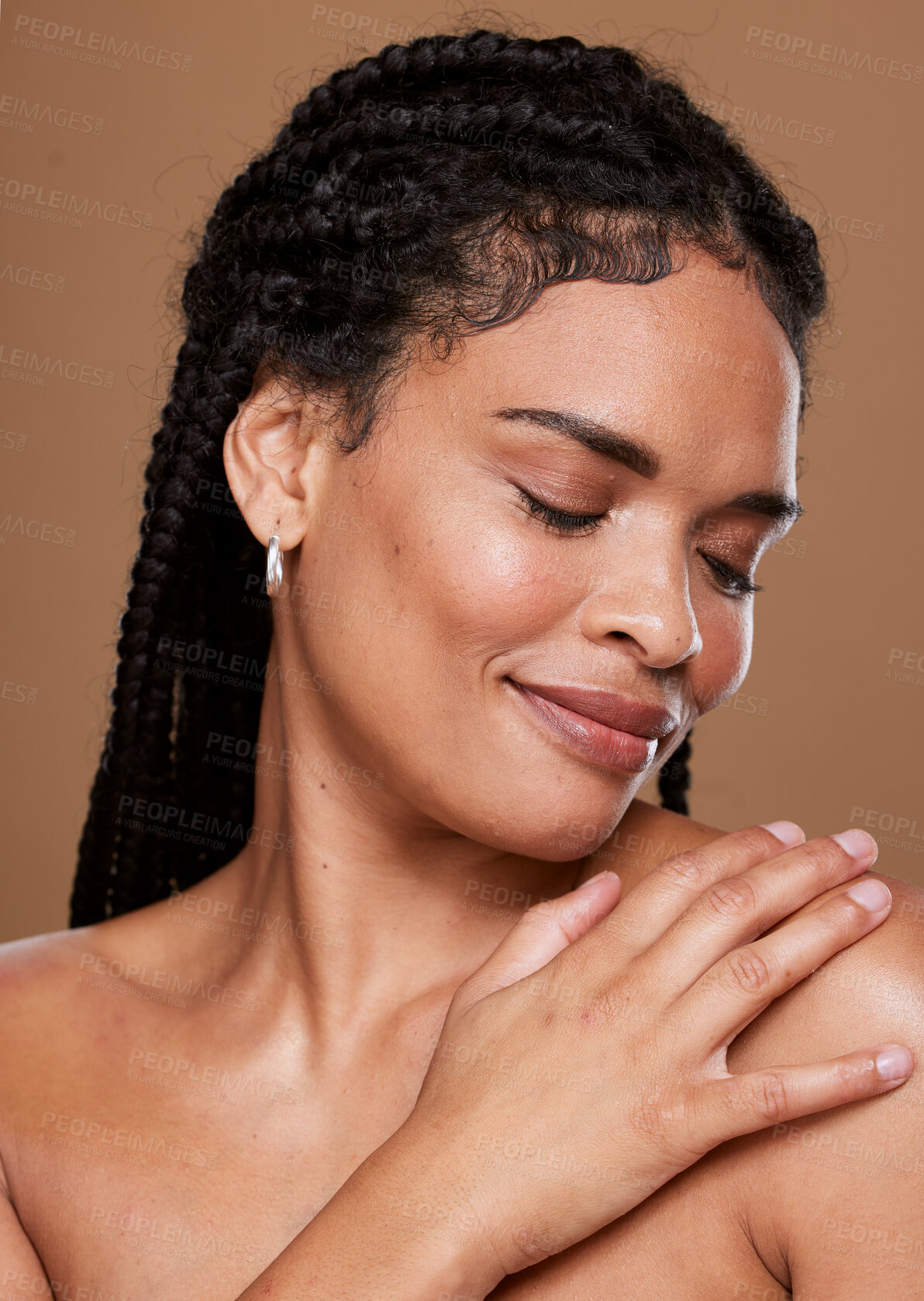 Buy stock photo Black woman, skincare and face with smile in relax for cosmetics or makeup against a brown studio background. African American female touching shoulder in satisfaction for soft beauty skin treatment