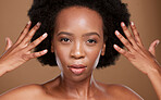 Hair care, beauty and portrait of a black woman with a wellness, health and curly routine in studio. Skincare, face and African model with natural hair and skin treatment isolated by brown background