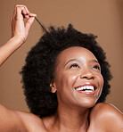 Black woman, afro and hair care, beauty and skincare for body wellness, cosmetics and curly hair maintenance on studio background. Happy, smile and young african girl model, hairstyle strand and face