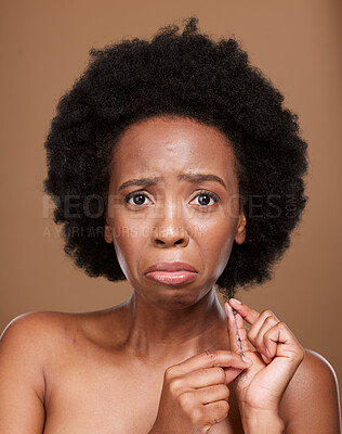 Buy stock photo Portrait, hair and black woman in studio for problem, breakage and split ends against a brown background mockup. Afro, face and girl model unhappy with natural hair, tangle and curls with mock up