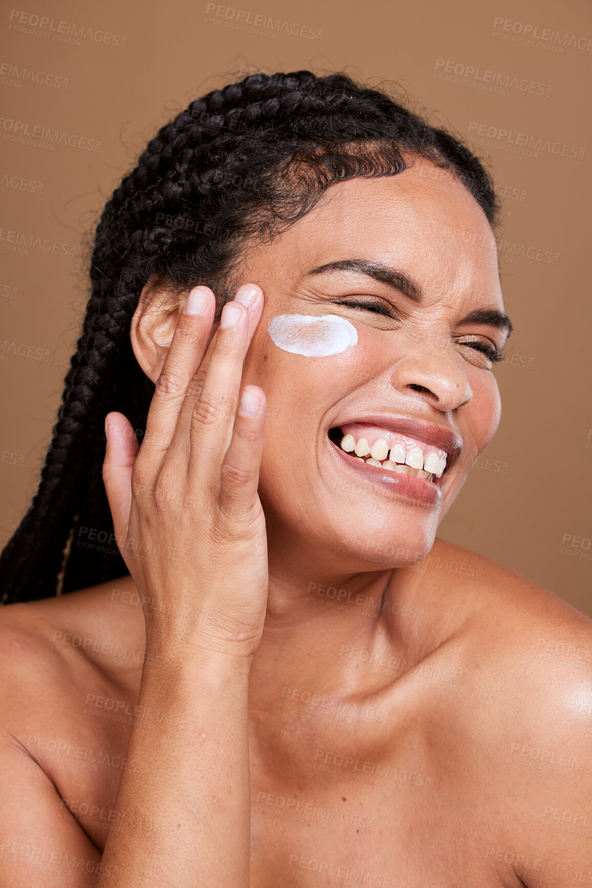 Buy stock photo Beauty, face cream and woman in studio, happy and relax with skincare, pamper and cleaning on brown background. Facial, sunscreen and face of black woman for self care with skin, product and cosmetic