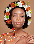 Portrait, beauty or makeup black woman with flower hair crown in brown studio background for skincare or luxury wellness. Spring, face cosmetics or model African American girl with flowers and rose 