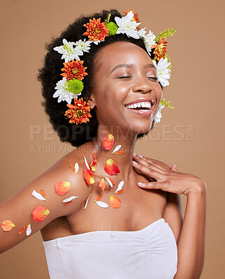 Buy stock photo Black woman, happy and flowers in studio for wellness, pamper and nature product against brown background. Smile, girl model and flower, crown and cosmetics for beauty, zen and aesthetic with mockup