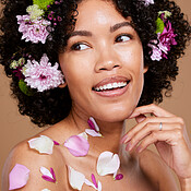 Beauty, makeup or black woman hair with flower portrait in brown studio ...