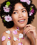 Beauty, makeup or black woman hair with flower portrait in brown studio background for skincare or luxury wellness with smile. Spring model, cosmetics or face of American girl with flowers for summer