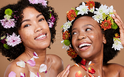 Buy stock photo Women, beauty and flowers in studio for wellness, cosmetic and grooming on brown background. Flower, crown and black woman friends relax, hygiene and pamper, nature product and zen plant aesthetic