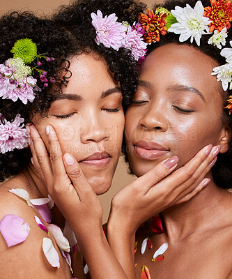 Buy stock photo Eyes closed, beauty and black women with flowers for skincare in studio on brown background. Organic cosmetics, makeup aesthetics and group, friends or female models with plants for healthy skin.