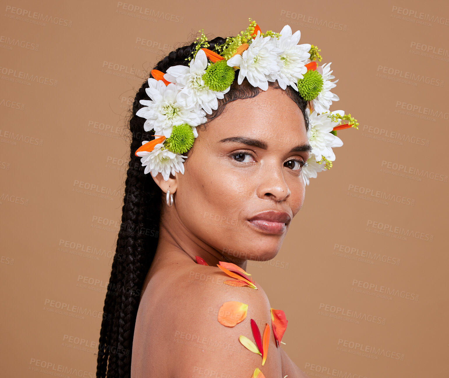 Buy stock photo Portrait, beauty and flowers with a model black woman in studio on a brown background for skincare or natural wellness. Crown, makeup and plant with an attractive young female posing for luxury