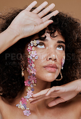 Buy stock photo Beauty, black woman and flower face makeup with natural skin thinking, surprised or curious. Hair care, facial or skincare model with healthy freckles and floral cosmetics in brown studio.


