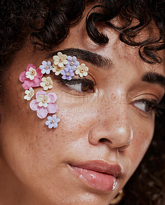 Buy stock photo Face, beauty and flowers with a model black woman closeup for skincare treatment or natural cosmetics. Spring, art and plant with the eyes of an attractive young female posing for makeup or wellness