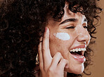 Cream, woman and skincare for wellness, natural beauty and confident on brown studio background. Cosmetics, female and girl with lotion, smooth face and organic facial with smile, happy and freckles.