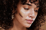 Woman, beauty and face with makeup and foundation for cosmetics and skintone shade. Cosmetic, beauty face and latino female with colour swatches on her skin for concealer product for cosmotology. 