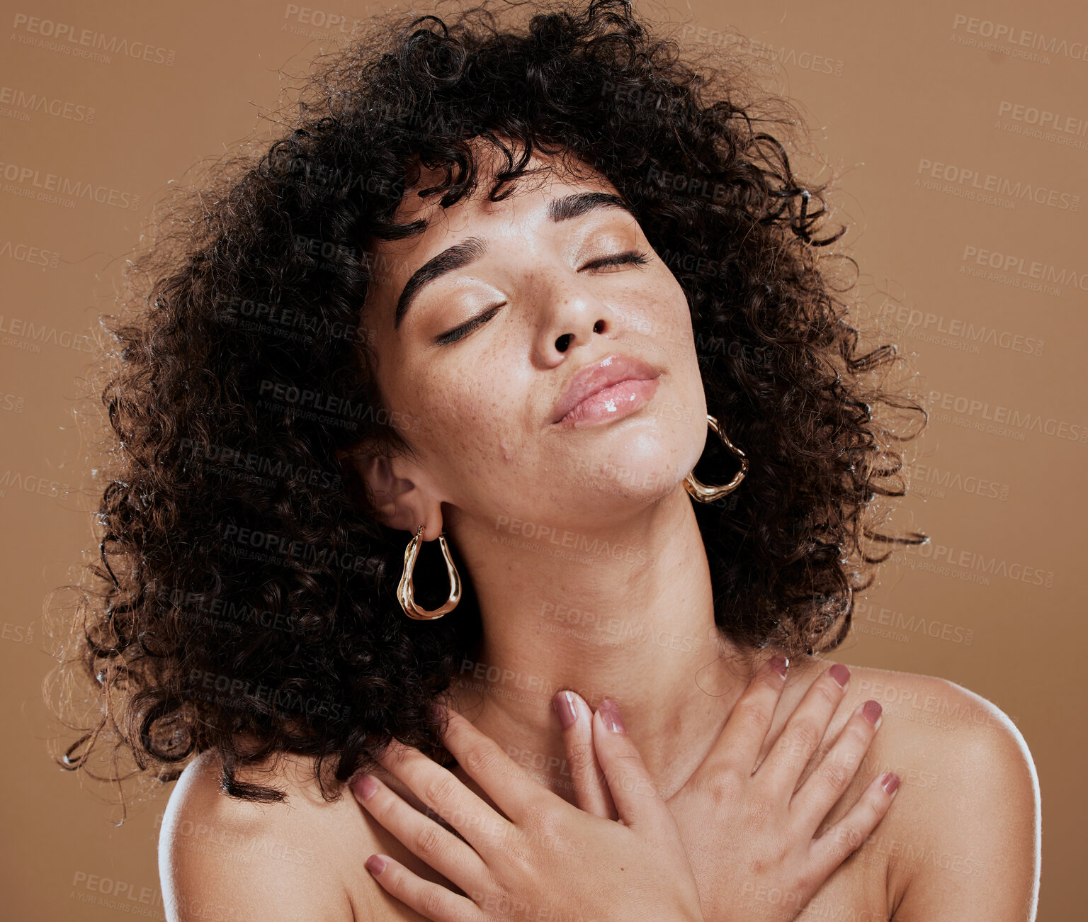 Buy stock photo Woman, afro and relax in beauty for skincare, cosmetics or makeup against a brown studio background. Female holding body in satisfaction for healthy wellness, hygiene or self love and self care