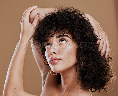 Buy stock photo Curly hair, woman and freckles, beauty and makeup for glow, shine and hair care on studio background. Young girl model, melasma face and natural cosmetics, clean skincare and dermatology aesthetics