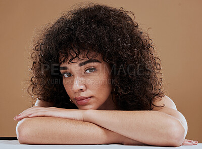 Buy stock photo Face, beauty and skincare with a model black woman in studio on a brown background for natural haircare. Portrait, cosmetics and wellness with an attractive young female posing to promote hair care