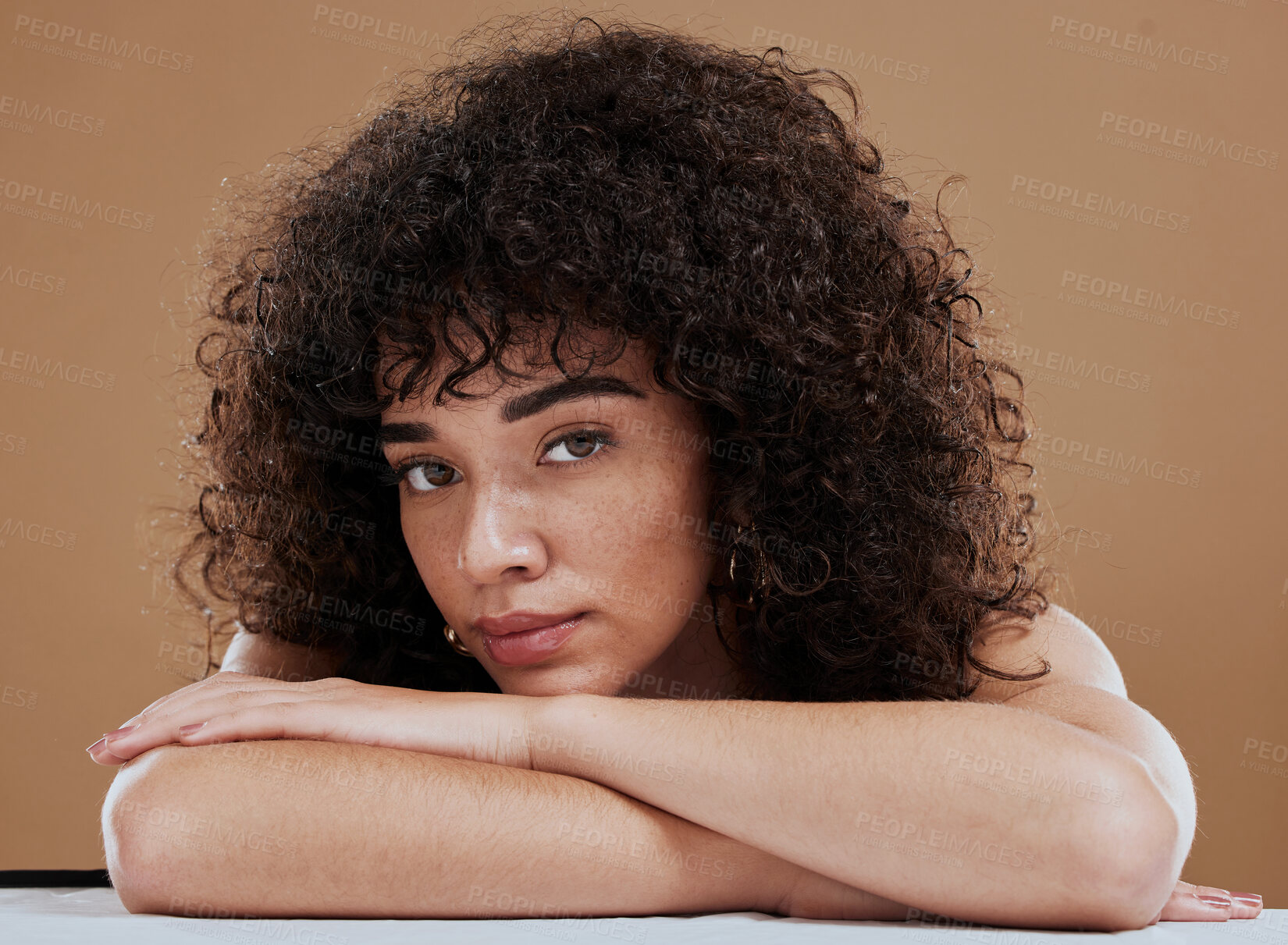 Buy stock photo Face, beauty and skincare with a model black woman in studio on a brown background for natural haircare. Portrait, cosmetics and wellness with an attractive young female posing to promote hair care