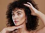 Face, hands and woman natural afro and skincare beauty or cosmetics makeup treatment. Luxury skin wellness, model facial care and healthy skin dermatology or hair care in brown studio background