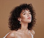 Black woman, beauty and skincare face portrait for natural body, facial or hair care cosmetics. Healthy, beautiful and assertive model with curly hair shine and texture in brown studio background.