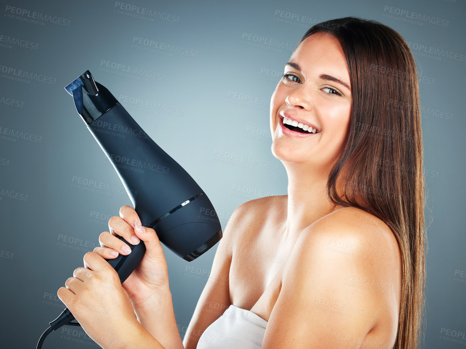 Buy stock photo Woman, hair dryer and salon with smile for beauty, skincare or cosmetics against a studio background. Portrait of happy female face smiling for hair care wellness or bathroom treatment on mockup