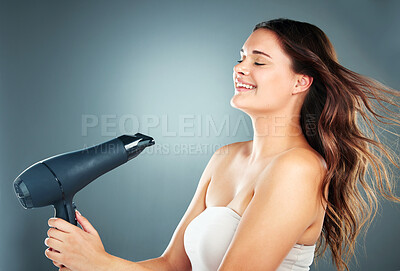 Buy stock photo Hair, dryer and woman in studio for beauty, grooming and hair care on a gradient background with mockup. Hairstyle, model and girl relax while styling, blowing and enjoy hygiene, fresh and treatment